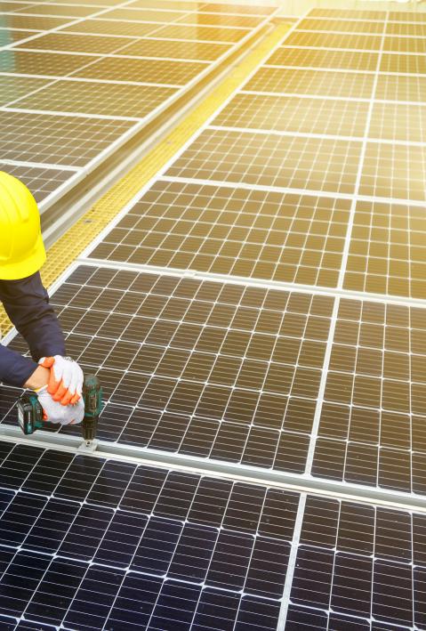 worker on solar panel