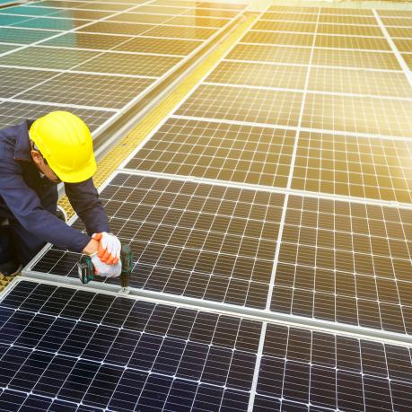 worker on solar panel