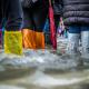 Flood on the streets, people wearing plastic bags on their shoes to walk through the water